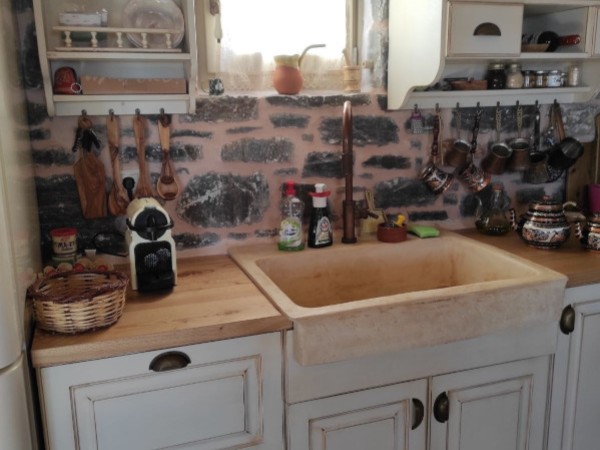 Rustic travertine stone kitchen sink with a trough