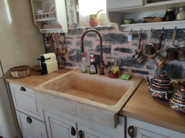 Rustic travertine stone kitchen sink with a trough