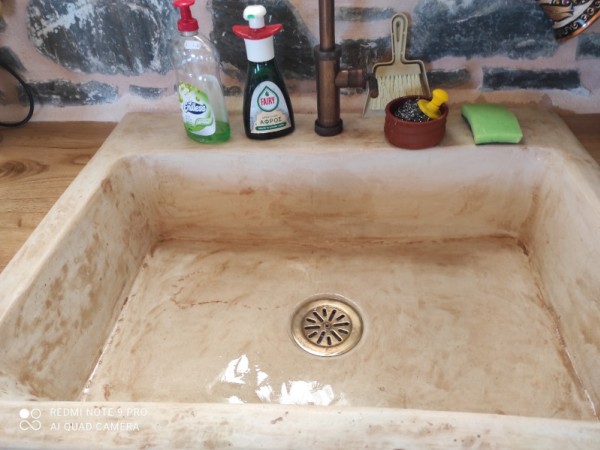 Rustic travertine stone kitchen sink with a trough