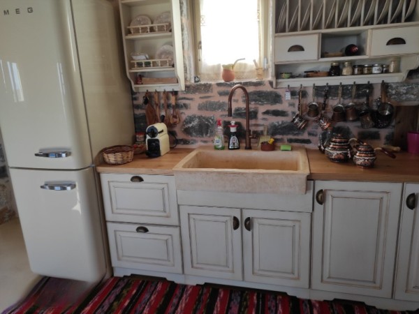 Rustic travertine stone kitchen sink with a trough